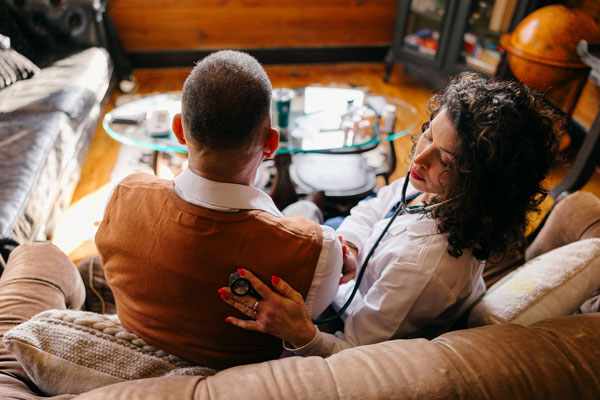 Patient having a physical exam in home by doctor