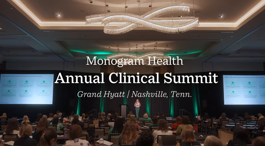 Stage with a presenter at Monogram Health's 2026 Clinical Summit.