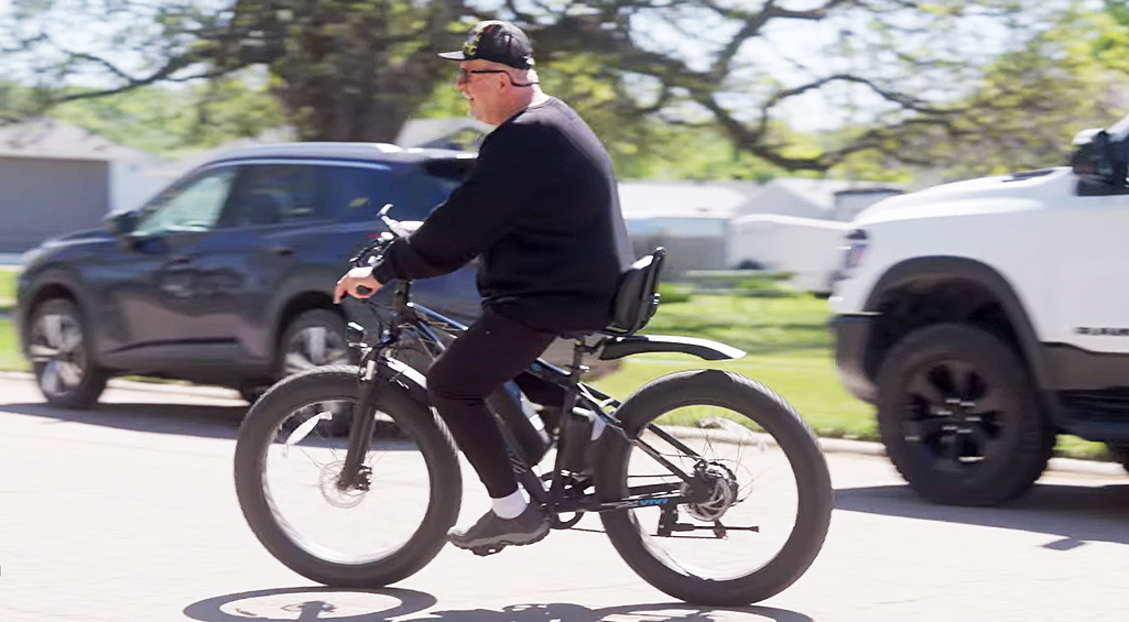 Monogram Health patient riding his electric bicycle
